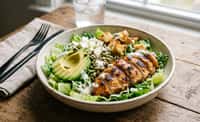 Charred Chicken Salad Bowl with Avocado, Feta, Yogurt Dressing, Croutons, and Pumpkin Seeds