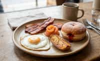 The Morning Plate with Fried Egg, Bacon, Smoked Salmon, Potato Wedge, and Strawberry Jam Doughnut